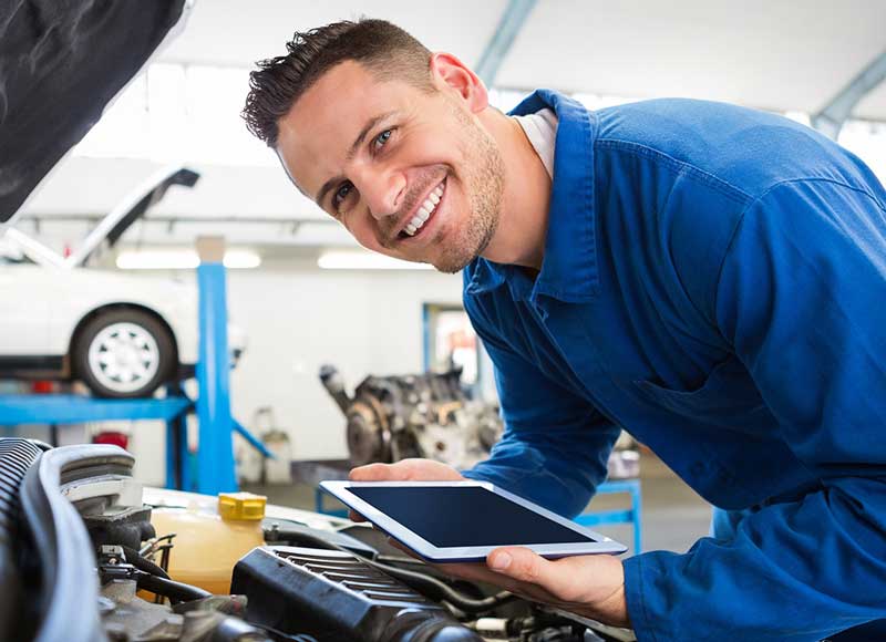 Chevrolet technician inspecting a vehicle